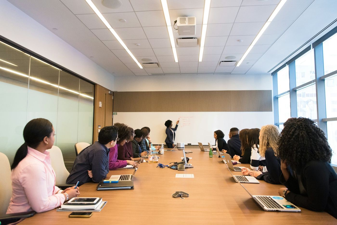 A team working together around a conference table with laptops open